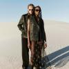 Two models wearing chic black outfits in the desert