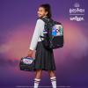 Girl in school uniform with purple Harry Potter accessories