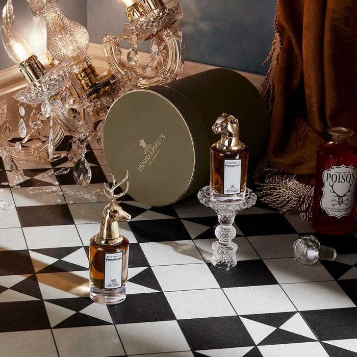 Vintage-style perfume bottles on black and white tiles
